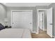 Bright bedroom featuring a closet with sliding doors and doorway to another room at 6842 Garland St, Arvada, CO 80004