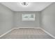 Cozy bedroom featuring carpet, ceiling fan and a window with view of the yard at 6842 Garland St, Arvada, CO 80004