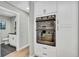 Modern kitchen with built in stainless steel appliances, and a view into the bathroom at 6842 Garland St, Arvada, CO 80004