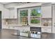Bright kitchen featuring stainless steel appliances, countertops, and a window with backyard views at 6842 Garland St, Arvada, CO 80004