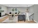 Stylish living room with modern furniture, a sleek fireplace, and a staircase at 6842 Garland St, Arvada, CO 80004
