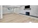 Spacious living room features hardwood floors, bright window and modern fireplace at 6842 Garland St, Arvada, CO 80004