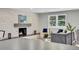 Stylish living room with modern furniture, a sleek fireplace, and bright windows at 6842 Garland St, Arvada, CO 80004