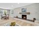 Bright living room featuring a modern fireplace, light wood floors, and contemporary decor at 6842 Garland St, Arvada, CO 80004