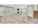 Finished basement with hardwood floors, white columns, and a modern marble fireplace at 6842 Garland St, Arvada, CO 80004