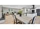 Open-concept living space featuring a modern kitchen, dining area, and a comfortable seating area at 6842 Garland St, Arvada, CO 80004