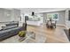Open-concept living space featuring a modern kitchen, dining area, and a comfortable seating area at 6842 Garland St, Arvada, CO 80004
