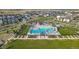 Aerial view of the community pool and surrounding neighborhood, featuring spacious green spaces at 9091 E 61St Ave, Denver, CO 80238