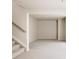 A finished basement area with neutral paint, carpeted floors, and staircase access at 9091 E 61St Ave, Denver, CO 80238