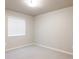 A bright, empty bedroom with neutral walls, carpet, and a window with white blinds at 9091 E 61St Ave, Denver, CO 80238