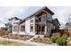 Striking exterior of a modern home featuring unique architectural details and manicured landscaping at 9091 E 61St Ave, Denver, CO 80238