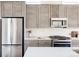 Modern kitchen featuring stainless steel appliances, light countertops, and wood-look cabinets at 9091 E 61St Ave, Denver, CO 80238