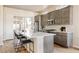 Spacious kitchen with a large island, modern appliances, and plenty of natural light at 9091 E 61St Ave, Denver, CO 80238