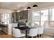 Stylish kitchen with a dark dining table and white chairs, stainless steel appliances, and ample counter space at 9091 E 61St Ave, Denver, CO 80238