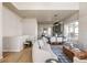 Bright, open-concept living area flowing into the dining room and kitchen with modern decor at 9091 E 61St Ave, Denver, CO 80238