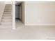 A light-filled living room with plush carpeting and a staircase leading to the upper level at 9091 E 61St Ave, Denver, CO 80238