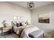 Neutral main bedroom features a modern light fixture, decor and ample natural light at 9091 E 61St Ave, Denver, CO 80238