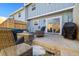 Cozy backyard patio with wicker furniture, a fire pit, and outdoor access to the house at 2540 E Geddes Pl, Centennial, CO 80122