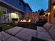 Inviting backyard patio with cozy seating, a fire pit, and a well-maintained artificial lawn at 2540 E Geddes Pl, Centennial, CO 80122
