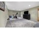Spacious basement area with carpet, workout equipment and a TV at 2540 E Geddes Pl, Centennial, CO 80122