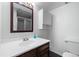 Bathroom featuring a vanity sink, large mirror and toilet at 2540 E Geddes Pl, Centennial, CO 80122