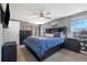 Spacious bedroom with neutral colors, ceiling fan and a large window for natural light at 2540 E Geddes Pl, Centennial, CO 80122