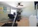 Green bedroom featuring a window, a ceiling fan, and a treadmill in the foreground at 2540 E Geddes Pl, Centennial, CO 80122