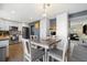 Stylish dining area with a modern chandelier and view into the kitchen and living space at 2540 E Geddes Pl, Centennial, CO 80122