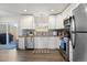 Updated kitchen with white cabinets, modern appliances, and sliding glass door at 2540 E Geddes Pl, Centennial, CO 80122