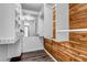 Spacious walk-in closet featuring custom shelving, wood accent wall, and modern flooring at 4206 E Maplewood Way, Centennial, CO 80121