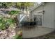 Outdoor patio with dining set, offering a serene space for relaxation and entertainment amidst lush landscaping at 100 Wildcat Ln, Boulder, CO 80304