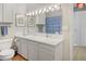 Bright bathroom with double sinks, vanity, and a blue shower curtain at 100 Wildcat Ln, Boulder, CO 80304