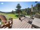Enjoy outdoor living on this deck, complete with seating and views of lush greenery and a blue sky at 100 Wildcat Ln, Boulder, CO 80304