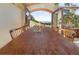 Dining room with a long wooden table, chairs, and scenic mountain view through arched double doors to outside deck at 100 Wildcat Ln, Boulder, CO 80304