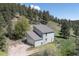 Two-story home featuring an attached garage and set amidst a lush, forested landscape in a serene setting at 100 Wildcat Ln, Boulder, CO 80304