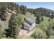 Aerial view of a light blue home nestled among lush trees, offering a serene and private setting at 100 Wildcat Ln, Boulder, CO 80304