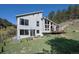 Modern home boasts large windows, a deck and lush greenery at 100 Wildcat Ln, Boulder, CO 80304