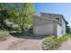 Home with an attached two car garage, landscaping and mature trees at 100 Wildcat Ln, Boulder, CO 80304