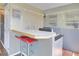 Kitchen featuring a breakfast bar with red stools, offering a cozy spot for casual dining and entertaining at 100 Wildcat Ln, Boulder, CO 80304