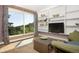 Living room featuring built-in shelves, a large window with scenic views, and comfortable seating area at 100 Wildcat Ln, Boulder, CO 80304