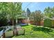 Backyard features raised garden beds, lush lawn, a shed, and a covered patio at 1109 Jersey St, Denver, CO 80220