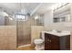 Bathroom features a tiled shower, a dark wood vanity, and updated fixtures at 1109 Jersey St, Denver, CO 80220