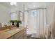 Bathroom featuring a tub and shower combo, a vanity with granite countertop, and tiled walls at 1109 Jersey St, Denver, CO 80220
