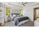 Serene bedroom boasts plush carpet, natural light from the windows, and calming neutral tones at 1109 Jersey St, Denver, CO 80220