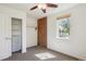 Minimalist bedroom with carpet flooring, exposed brick feature, and closet with white sliding doors at 1109 Jersey St, Denver, CO 80220