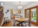 Cozy dining area showcasing hardwood floors and access to the kitchen and backyard at 1109 Jersey St, Denver, CO 80220