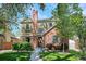 Charming two-story home featuring brick and siding, complemented by lush landscaping and a welcoming walkway at 1109 Jersey St, Denver, CO 80220