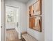 Hallway showcasing artwork and leading to a bright bathroom featuring a double sink and vanity at 1109 Jersey St, Denver, CO 80220