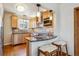 Updated kitchen with stainless steel appliances and breakfast bar at 1109 Jersey St, Denver, CO 80220