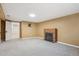 Spacious living room features neutral carpet, a brick fireplace, and a large window for natural light at 1109 Jersey St, Denver, CO 80220